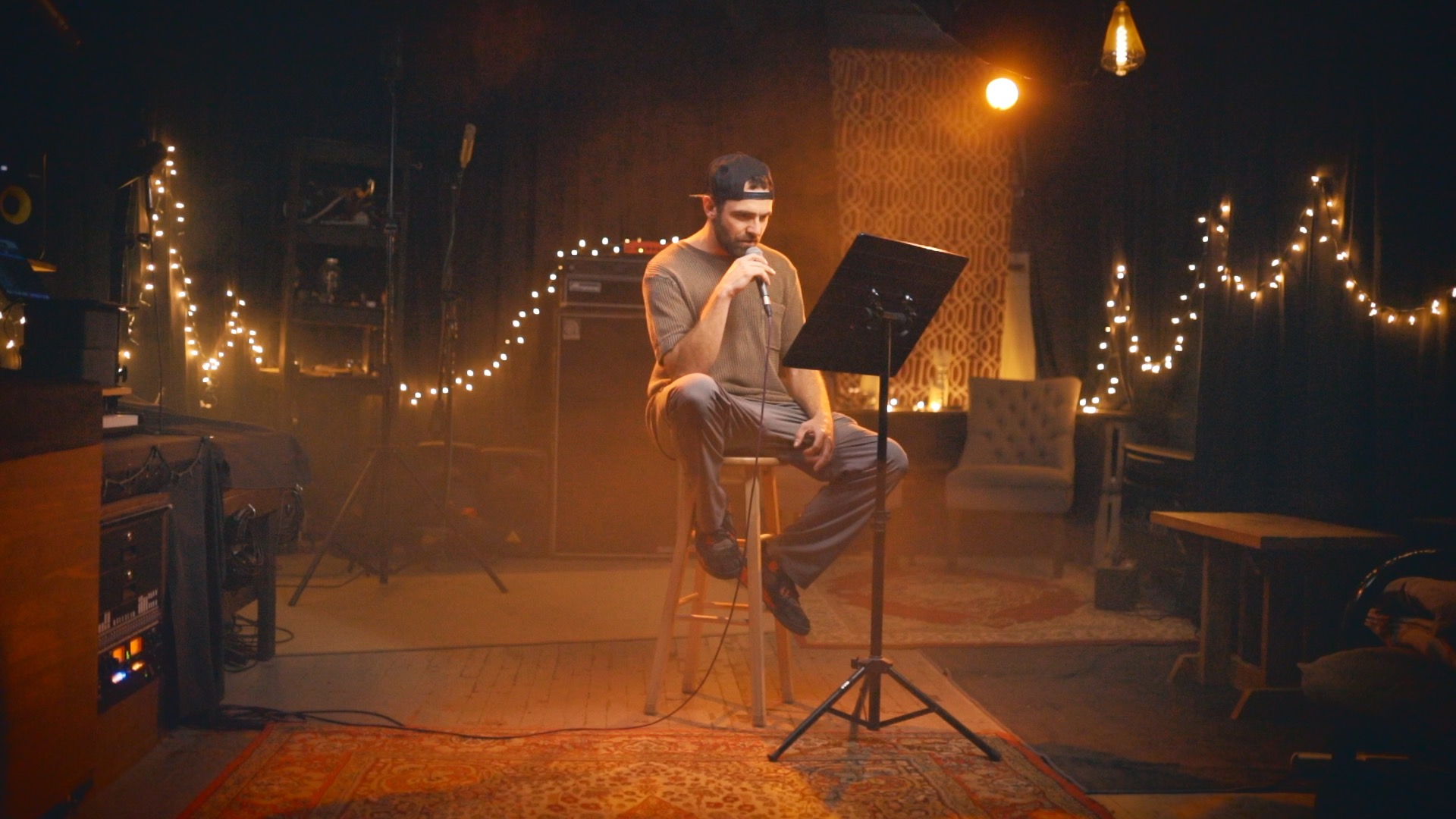 Bergdawg seated with microphone in studio